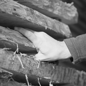 hand touching wooden planks